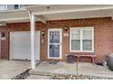 Close up shot of the front entry with brick facade, attached garage, and covered entrance at 9769 Green Knoll Dr, Noblesville, IN 46060