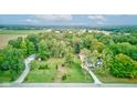 An aerial view of the property showcasing lush greenery, mature trees, and a sprawling lawn at Vacant Lot 0 - 5750 W 650 N, Thorntown, IN 46071