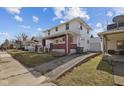 Two story home showing the side yard, driveway, and proximity to neighboring houses at 1023 W 7Th St, Anderson, IN 46016