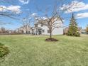 A large backyard with healthy green grass, surrounded by a privacy fence at 10827 Putnam Pl, Carmel, IN 46032