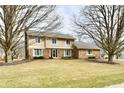Charming two-story home with a brick and siding exterior and a well-maintained front lawn at 1120 Williamsburg Ln, Zionsville, IN 46077