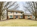 Charming two-story home with a brick and siding exterior and a well-maintained front lawn at 1120 Williamsburg Ln, Zionsville, IN 46077