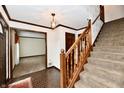 Inviting foyer with hardwood floors, staircase, and decorative lighting fixture at 1120 Williamsburg Ln, Zionsville, IN 46077