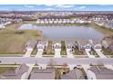 Stunning aerial view of a residential area with a tranquil pond, showcasing a vibrant community at 11430 Congaree Way, Indianapolis, IN 46235