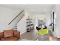 Open floorplan with hardwood floors, a living room, dining area, and modern decor, offering a seamless flow at 139 Mckim Ave, Indianapolis, IN 46201
