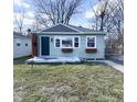 Charming home with muted green siding, gray accent shingles, and simple landscaping at 1836 N Riley Ave, Indianapolis, IN 46218