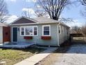 Charming home with muted green siding, gray accent shingles, and simple landscaping at 1836 N Riley Ave, Indianapolis, IN 46218