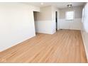 Bright living room with wood floors and white wainscoting at 1836 N Riley Ave, Indianapolis, IN 46218