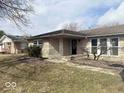 Inviting single-story home featuring a covered front porch with stone pillars and manicured landscaping at 2104 W Barcelona Dr, Muncie, IN 47304