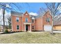 Charming two-story brick home featuring an attached two-car garage and a well-manicured front lawn at 21241 Carlton Ct, Noblesville, IN 46062