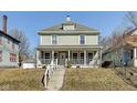 Charming two-story home featuring a large, inviting front porch with classic architectural details at 2308 Nowland Ave, Indianapolis, IN 46201
