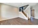Bright living room featuring sleek hardwood floors, a staircase, and a modern color palette at 2308 Nowland Ave, Indianapolis, IN 46201