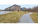 Scenic view of townhomes with green lawns and a charming walking path at 348 Brunswick Way, Zionsville, IN 46077