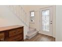 Bright foyer with a staircase, a decorative front door, and a classic wood dresser at 3642 Homestead W Cir, Plainfield, IN 46168
