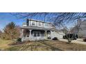 Charming two-story home with gray siding, white trim, inviting front porch, and attached two-car garage at 3642 Homestead W Cir, Plainfield, IN 46168