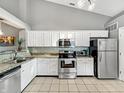 Bright kitchen featuring white cabinets, stainless steel appliances, and tile backsplash at 3708 Magenta Ln # 3, Indianapolis, IN 46214