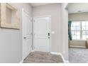 Inviting entryway featuring wood-look floors and a modern front door at 389 Longleaf Ln, Greenfield, IN 46140