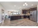 Modern kitchen featuring stainless steel appliances, dark cabinets, and an open layout at 389 Longleaf Ln, Greenfield, IN 46140