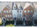 Birds-eye view showcasing brick townhouse exteriors with dormer windows and dark grey roofs at 427 Windham Pass, Carmel, IN 46032