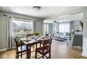 Open floor plan with dining area and living room featuring modern decor and natural light at 4559 Bonnie Brae St, Indianapolis, IN 46228