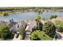 An aerial view of a home near a lakefront community and lush landscaping at 4615 Crystal Lake Dr, Indianapolis, IN 46240