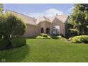 Beautiful brick home with lush landscaping and a well-maintained lawn at 4615 Crystal Lake Dr, Indianapolis, IN 46240