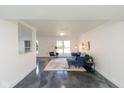 Bright, open living room with polished floors and stylish blue furnishings creating a contemporary feel at 5034 Allisonville Rd # A, Indianapolis, IN 46205
