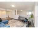 Open-concept living space with polished floors, modern furniture, and abundant natural light at 5034 Allisonville Rd # A, Indianapolis, IN 46205