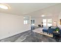 Spacious living area with polished floors, neutral walls, and a modern design aesthetic at 5034 Allisonville Rd # A, Indianapolis, IN 46205