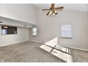 Bright living room with vaulted ceilings, large windows, and neutral carpet flooring for a cozy atmosphere at 509 Yorktown Ln, Avon, IN 46123