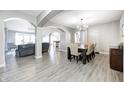 Open-concept dining room featuring hardwood floors, neutral walls and stylish chandelier with easy access to the living room at 5524 Goodwin St, Indianapolis, IN 46234