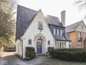 Charming home with a beautiful slate roof, arched doorway, and manicured landscaping creating curb appeal at 6009 N Washington Blvd, Indianapolis, IN 46220