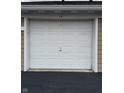 Single-car garage with a white panel door, providing secure parking and storage space at 6526 Jade Stream Ct # 309, Indianapolis, IN 46237