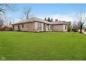 Beautifully landscaped home with a lush green lawn at 6528 Hedback Dr, Indianapolis, IN 46220
