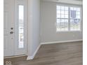Bright entryway featuring durable floors, a white front door and frame, and a large window at 7181 Barrett Dr, Brownsburg, IN 46112