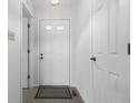 Bright entryway with tile flooring, a coat closet, and a neutral color palette at 7463 Pebblebrooke W Dr, Indianapolis, IN 46236
