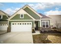 Charming green home featuring a brick foundation and an attached two-car garage and long drive at 761 Stone Trace Ct, Avon, IN 46123