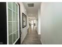 Bright foyer with wood-look flooring, white walls, and view into an open-concept living space at 761 Stone Trace Ct, Avon, IN 46123