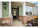 Inviting front porch with brick accents, white columns, and a classic black front door at 761 Stone Trace Ct, Avon, IN 46123