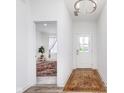 Bright foyer features wood-look floors, modern light fixtures, and views into adjacent rooms, creating an inviting entrance at 7658 Hillway Dr, Indianapolis, IN 46113