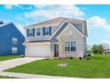Two-story home with blue shutters, a well-maintained lawn, and a two-car garage, blending traditional and modern design elements at 7658 Hillway Dr, Indianapolis, IN 46113