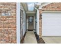 Inviting front door with a glass pane and sidelights, framed by brick and siding at 7848 Cork Bend Ln, Indianapolis, IN 46239