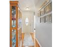 Entryway featuring hardwood floors, a display cabinet and Gathering photos on the wall at 7848 Cork Bend Ln, Indianapolis, IN 46239