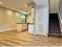 Open kitchenette features an island with seating and modern pendant lighting at 857 N Oakland Ave, Indianapolis, IN 46201