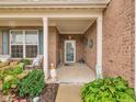 A welcoming front porch with brick columns, seating, and decorative touches adding charm at 8727 Faulkner Dr, Indianapolis, IN 46239
