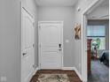 Bright hallway with white doors and a rug leading into the home at 8727 Faulkner Dr, Indianapolis, IN 46239