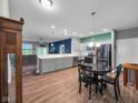 Open kitchen featuring gray cabinets, stainless steel appliances, island and modern pendant lighting at 8727 Faulkner Dr, Indianapolis, IN 46239