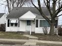 Charming bungalow-style home with white siding, classic black shutters, and well-maintained front yard at 1023 Union St, Columbus, IN 47201