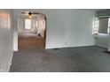 Spacious living room featuring new gray carpeting and a large arched doorway to other rooms at 1023 Union St, Columbus, IN 47201