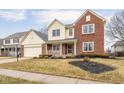Beautiful two-story home featuring brick and siding exterior, a covered porch, and an attached two-car garage at 11866 Weathered Edge Dr, Fishers, IN 46037